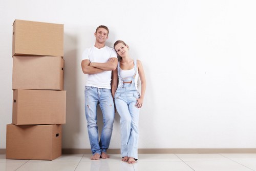 Professional flat removals team handling boxes in Chelsea apartment