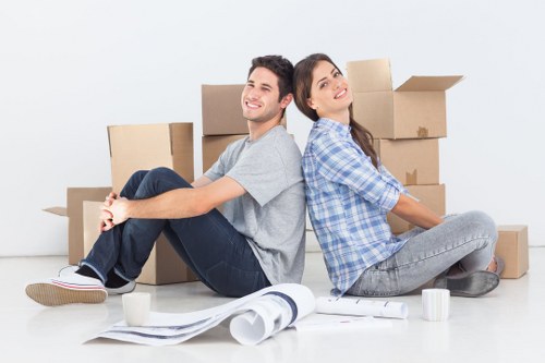 Business relocation team packing office furniture carefully