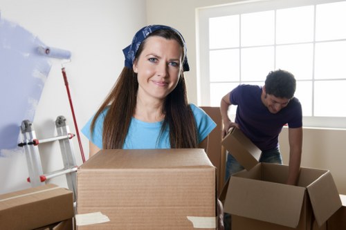 Professional movers loading furniture into a Chelsea removal van