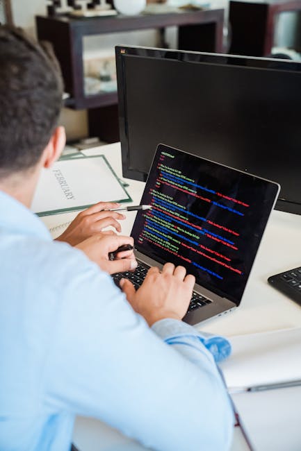 Close-up image of a computer screen displaying lines of HTML and CSS code with coloured syntax highlighting, including tags for headings, images, and classes. The code appears to be related to web dev